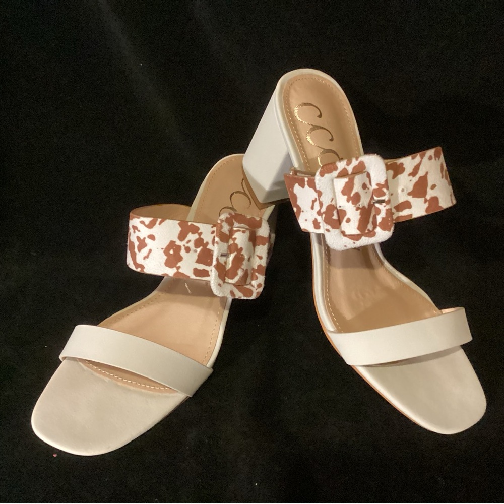 Ccocci brand sandal, size 7, off-white with brown and white buckle accent strap.
